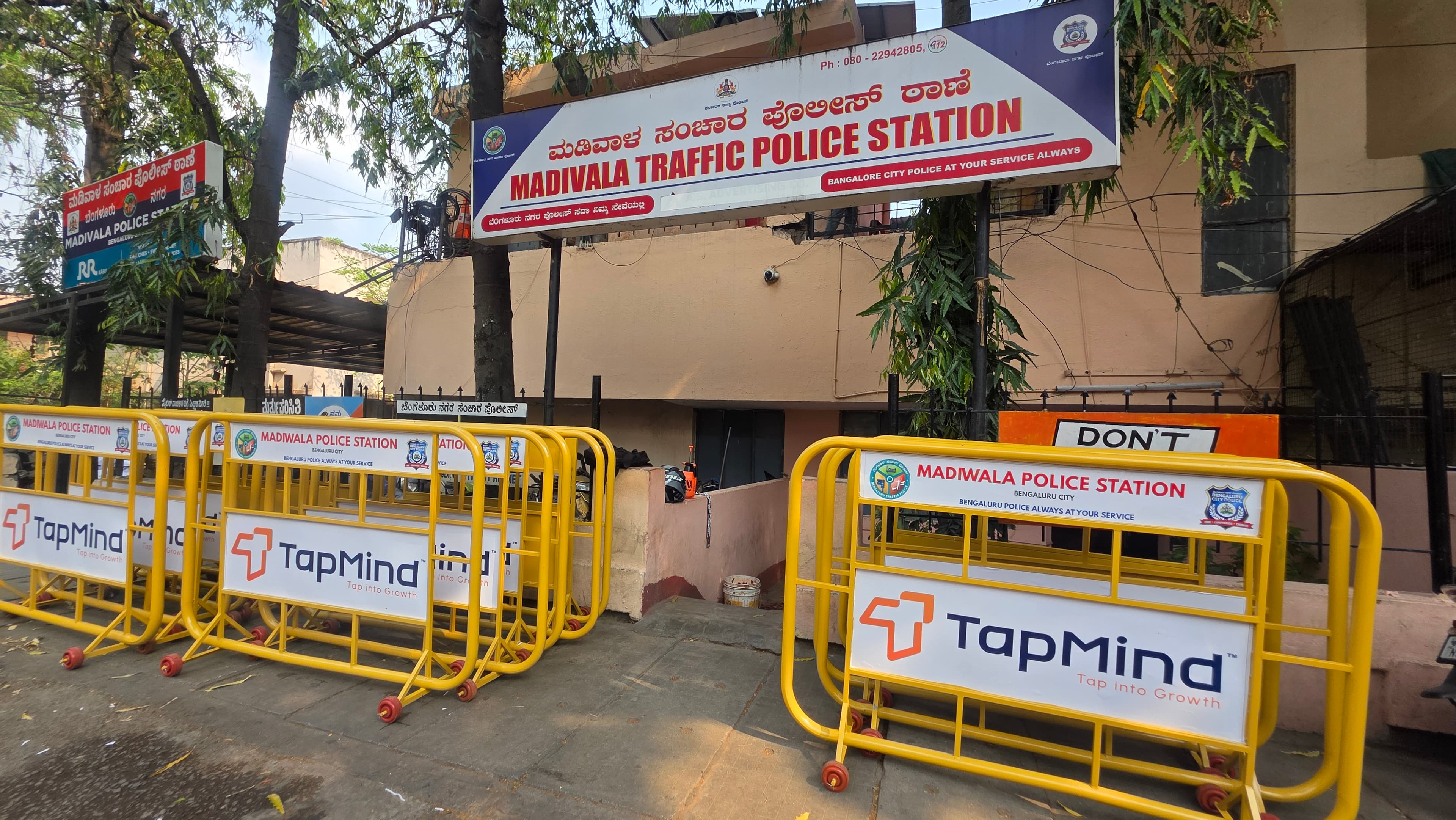 TapMind-branded traffic barricades outside Madivala Traffic Police Station