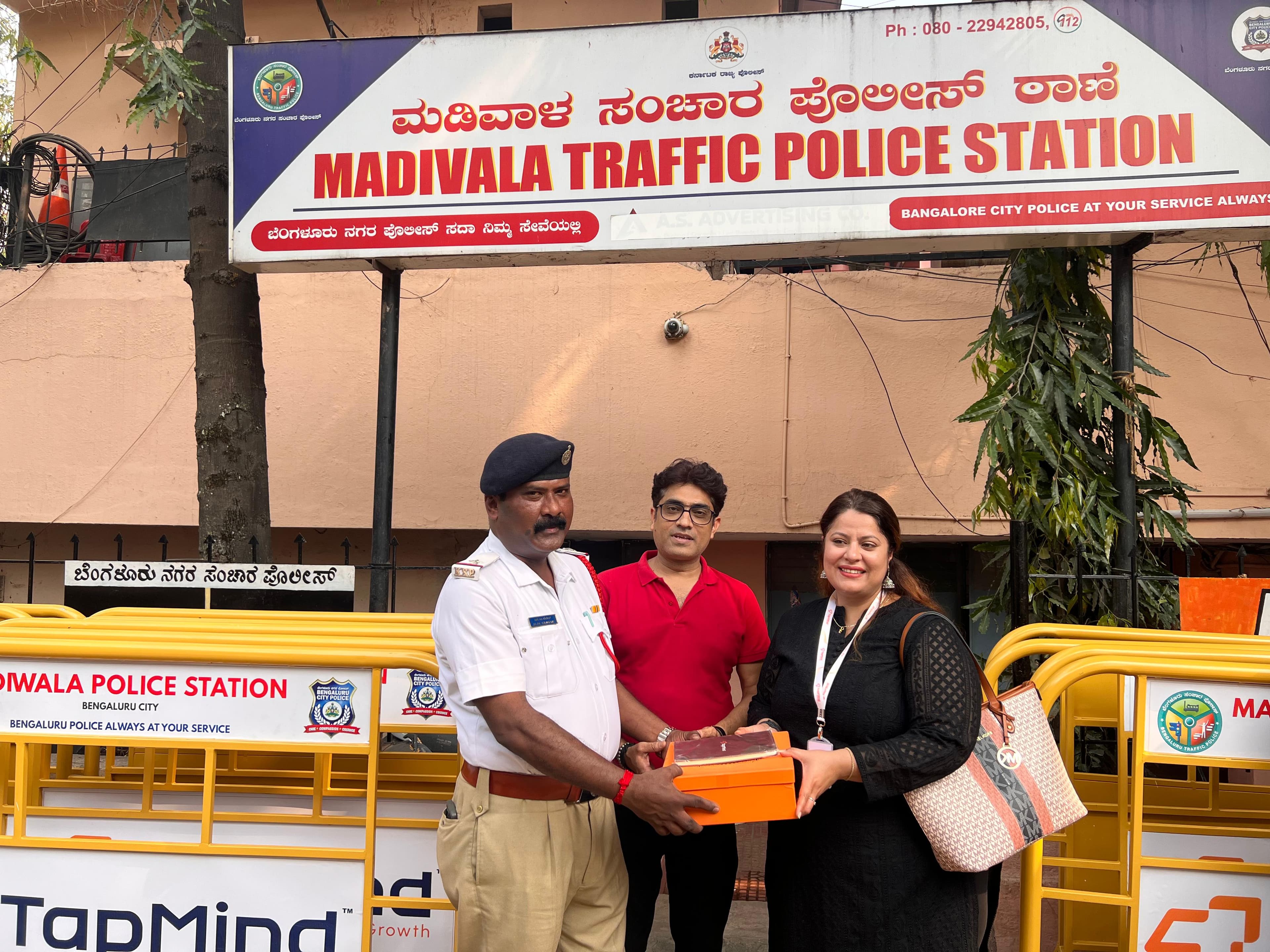 TapMind representatives with a traffic police officer at Madivala Traffic Police Station