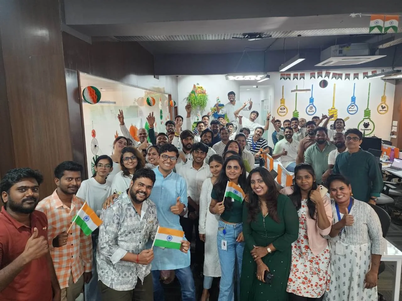 Team celebrating together with Indian flags